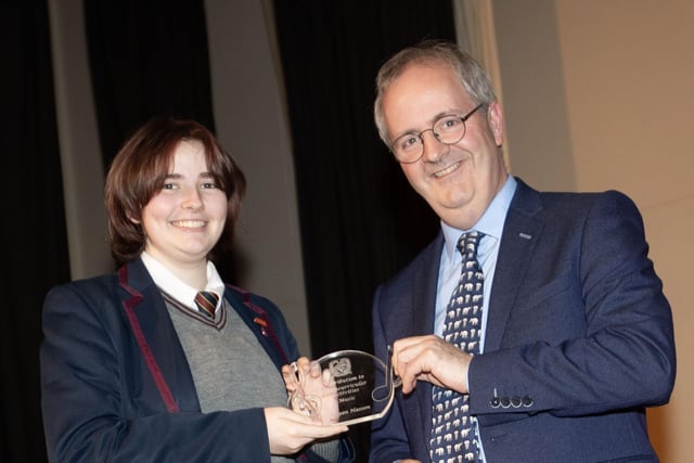 Mr. John Harkin, Principal, Oakgrove Integrated College, pictured presenting the Contribution to Extra Curricular Activities in Music to Megan.