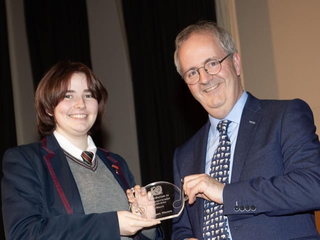 Mr. John Harkin, Principal, Oakgrove Integrated College, pictured presenting the Contribution to Extra Curricular Activities in Music to Megan.