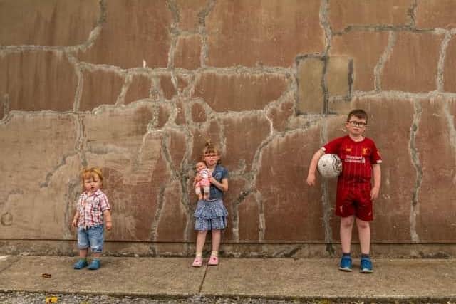 Tiernan Long from Inch Island, pictured last year with his younger siblings Samarah and Matthew outside their Mica damaged home. (Photo: Brendan Diver)