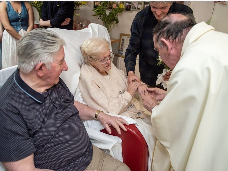 Father Paddy Doherty placing a wedding ring Charlie got his daughter Frances to retrieve from Cooley's on Molly's finger.