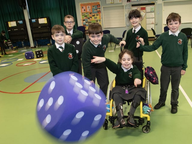 Amelie makes it simple by closing her eyes and throwing the dice, carefully watched by Daibhin, Rogan, George, Darragh and Emmett. (Photos: Jim McCafferty Photography)