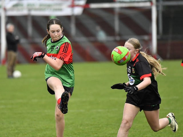 Young footballers from Doire Trasna and Slaughtmanus Under 12 teams play at half-time at the Derry Junior Football Championship Final held in Celtic Park on Sunday afternoon. Photo: George Sweeney