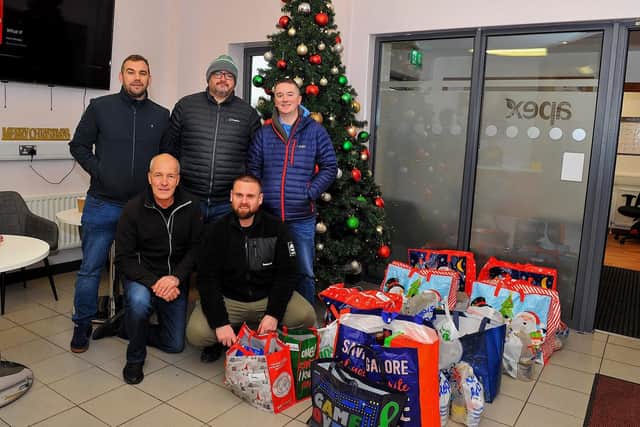 Volunteers from Invista’s Lycra plant at Maydown at the Foyle Foodbank distribution centre on Wednesday morning, Photo: George Sweeney. DER2250GS – 24