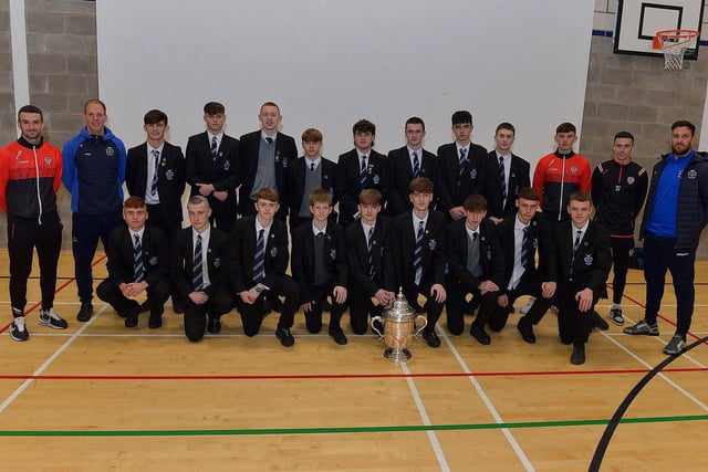 Derry City players Michael Duffy, Liam Mullan and Jordon McEneff pictured with St Columb's College Year 12 pupils and PE teachers James Green and Mark Scoltock during a visit to the school, with the FAI Cup on Monday. Photo: George Sweeney. DER2247GS - 28