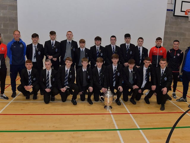 Derry City players Michael Duffy, Liam Mullan and Jordon McEneff pictured with St Columb's College Year 12 pupils and PE teachers James Green and Mark Scoltock during a visit to the school, with the FAI Cup on Monday. Photo: George Sweeney. DER2247GS - 28