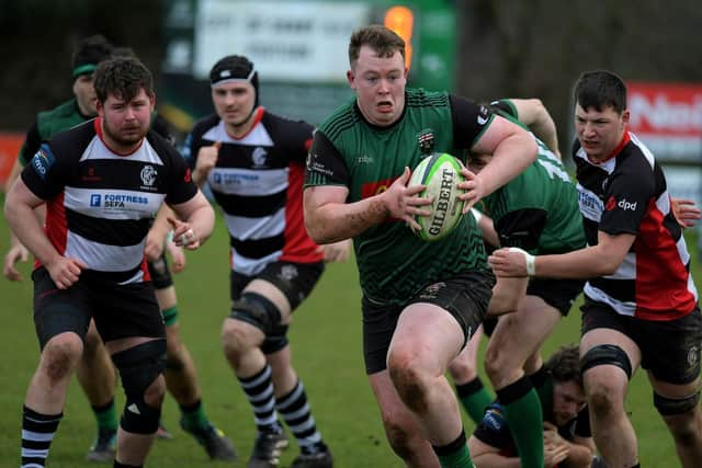 City of Derry’s Fearghus Canning bursts through Cooke’s defensive cover. Photo: George Sweeney