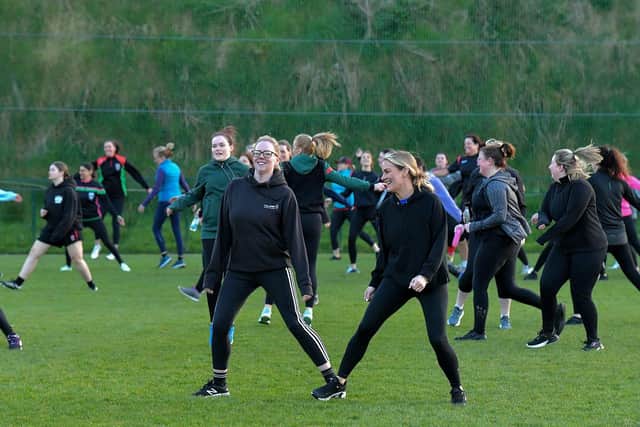 Warm-up exercises ahead of Doire Trasna’s first Mothers and Others football practice session, at Corrody Road. Photo: George Sweeney. DER2316GS – 09