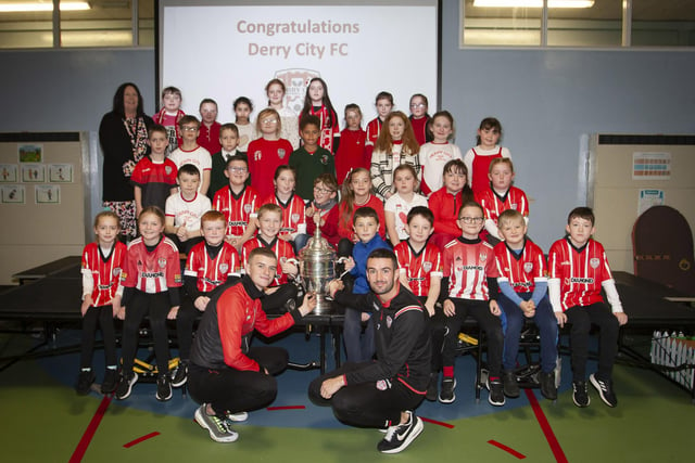 Derry players Caoimhin Porter and Michael Duffy and the FAI Cup pictured with the P5 classes at Greenhaw PS.