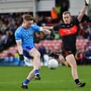 Niall O’Donnell of Ballinderry gets off a shot as Carrickcruppen’s Oisin O’Hare closes in. Photo: George Sweeney