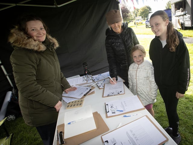 Tansy McLaughlin looking after registration during Saturday's Waterside Together Mini Festival at Woodburn Urban Park. : .
