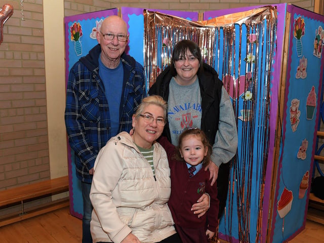 Rodney Smith, Elaine McIntyre and Majella Neeson with Gracie at St John’s PS Grandparents Vintage Tea. Photo: George Sweeney