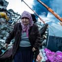 HATAY, TURKEY - FEBRUARY 07: A woman waits for news of her loved ones, believed to be trapped under collapsed building on February 07, 2023 in Iskenderun, Turkey. A 7.8-magnitude earthquake hit near Gaziantep, Turkey, in the early hours of Monday, followed by another 7.5-magnitude tremor just after midday. The quakes caused widespread destruction in southern Turkey and northern Syria and were felt in nearby countries.  (Photo by Burak Kara/Getty Images)