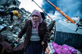 HATAY, TURKEY - FEBRUARY 07: A woman waits for news of her loved ones, believed to be trapped under collapsed building on February 07, 2023 in Iskenderun, Turkey. A 7.8-magnitude earthquake hit near Gaziantep, Turkey, in the early hours of Monday, followed by another 7.5-magnitude tremor just after midday. The quakes caused widespread destruction in southern Turkey and northern Syria and were felt in nearby countries.  (Photo by Burak Kara/Getty Images)
