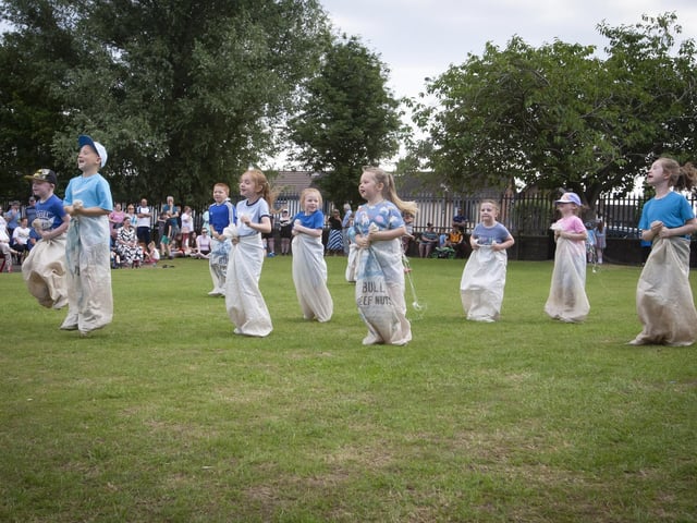 Fun and frolics in one of the sack races on Friday last.
