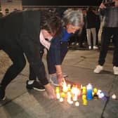 Local people place candles during a prayer vigil in Carndonagh, Donegal in solidarity with the people of Creeslough.