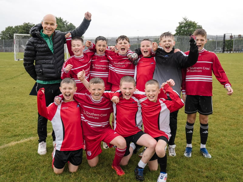 The jubilant St. Anne's PS team celebrate victory in the Sean O'Kane Perpetual Cup final on Thursday last.