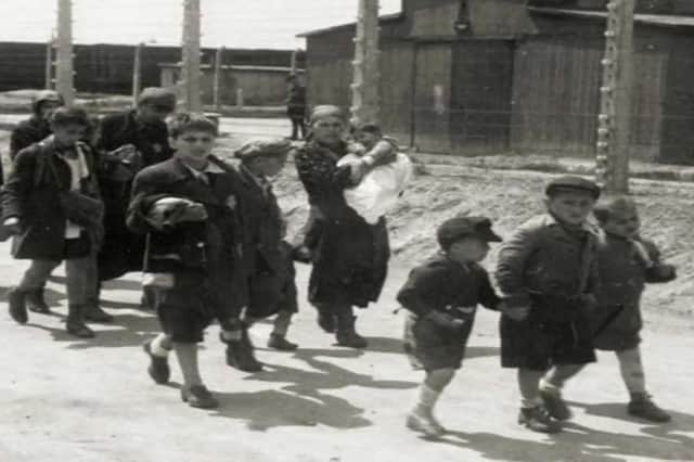 Children and adults  arriving in Auschwitz, as displayed in one of the photos at the Auschwitz site (Photo: Brendan McDaid/ Derry Journal)