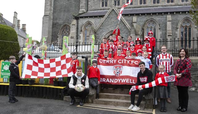 Members of the St. Eugene’s PS school football team show their support for Derry City.