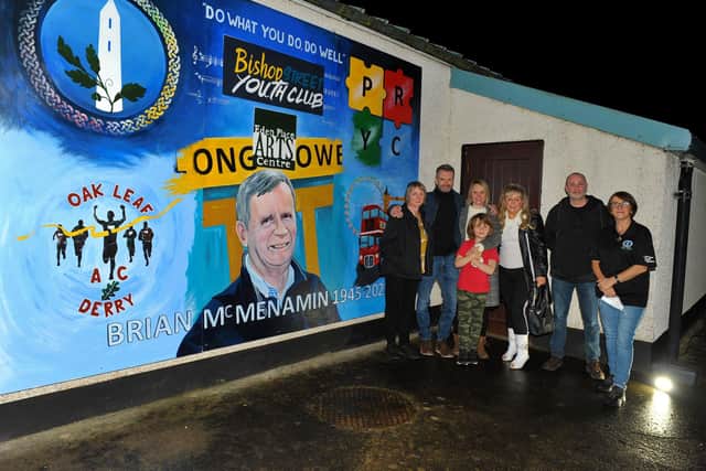 2021: A mural dedicated to the late Brian McMenamin, a Youth Worker for over 40 years was unveiled at the Long Tower Youth Club. Pictured from left are Judi Logue, Paul McMenamin, Michelle McMenamin, Noah Gibson, Patricia McMenamin, Paddy Doherty, mural artist and Monica Jarvis, Long Tower Youth Club. Photo: George Sweeney.  DER2145GS – 061