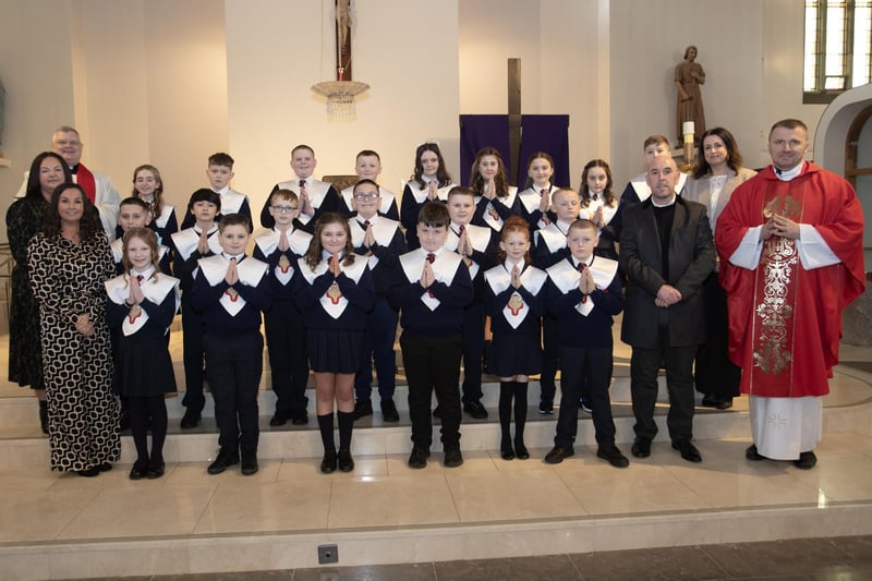 Pupils from Holy Child Primary School, Creggan, Derry who received the Sacrament of Confirmation from Fr. Ignacy Sanuita, CC, at St. Mary's Church on Friday afternoon last. Included in photo are from left, Mrs. Pat Concannon, Princpal, Fr. Daniel McFaul, PP, and on right, Mr. David O'Donnell, P7 Teacher. (Photo: Jim McCafferty Photography)