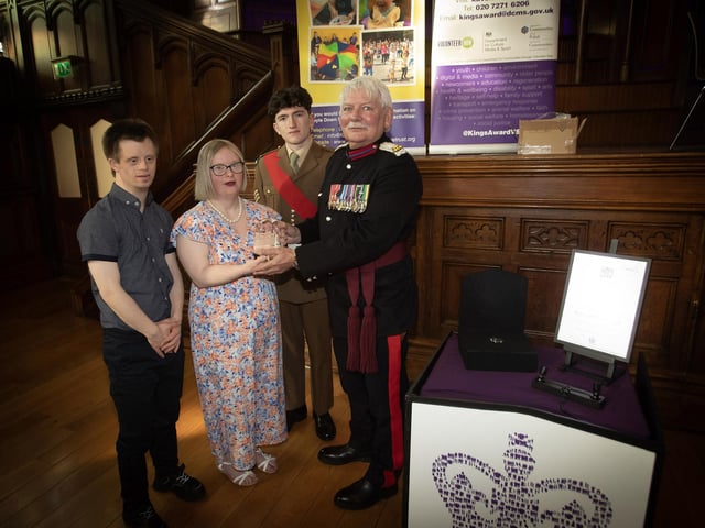 The Vice Lord Lieutenant Alan Moore, OBE, presenting the King's Award for Voluntary Service to Laura Duddy and Benjamin Thompson, Foyle Down Syndrome Trust, in the Guildhall on Friday last. At back is Sgt. Niall Downey, Irish Guards. (Photos: Jim McCafferty Photography)