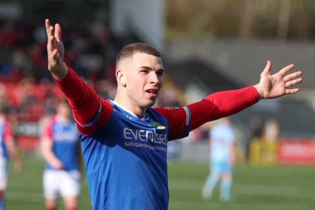 Linfield's Ethan Magee celebrates opening the scoring against Institute.