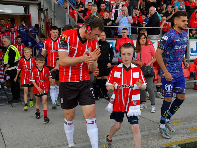 Mascots and Derry City players make their way onto the pitch on Friday evening. Photo: George Sweeney. DER2322GS – 151