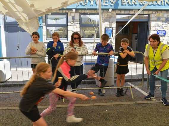 Spectators at the egg and spoon race during the Carndonagh Family Fun Day 'Live in the Marquee' on Saturday afternoon last. Photo: George Sweeney. DER2327GS - 096