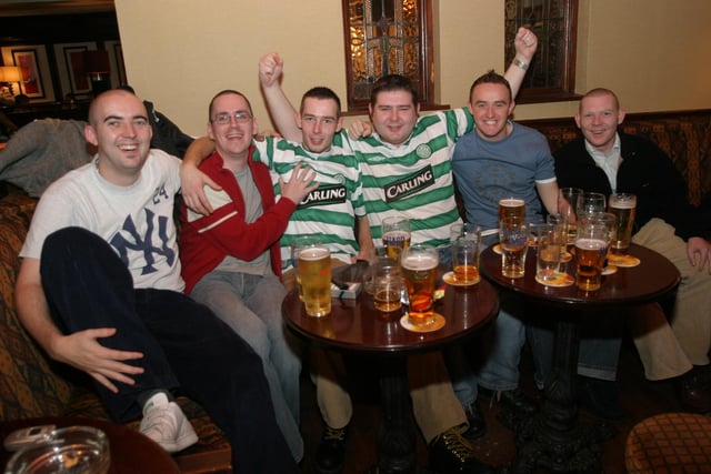 A group of Celtic supporters watching the match in The Delacroix in January 2004.