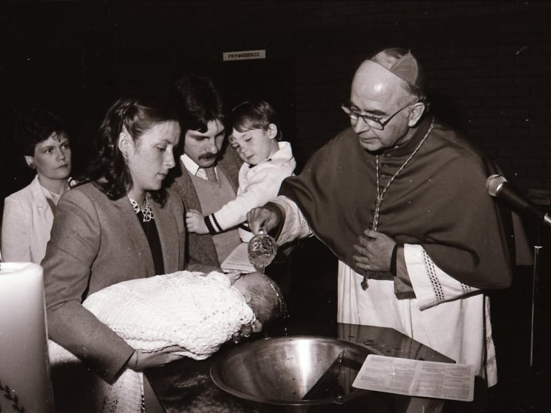 Bishop Daly with newly baptised infants at Holy Family Church during pastoral visitation to Ballymagroarty.