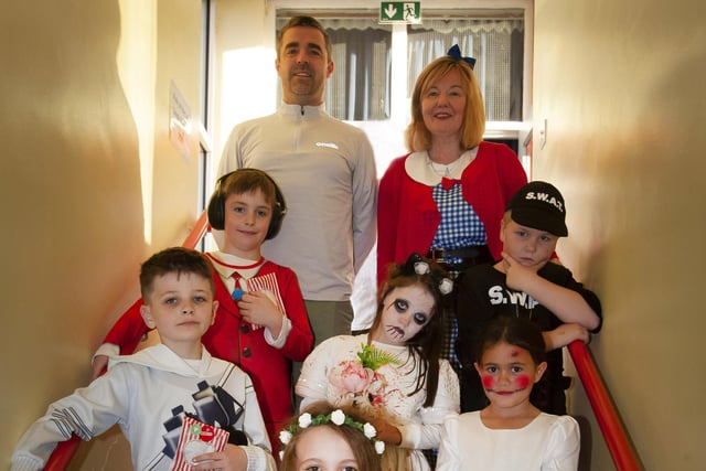 Mr Siobhan Gillen, (Principal) and Mr McLaughlin (Teacher) with some of the children from his Primary 4 class during last week’s Halloween celebrations at Steelstown PS.