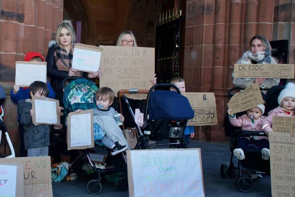 People who have been allocated new homes but have not yet got their keys protest outside the Guildhall during the meeting.