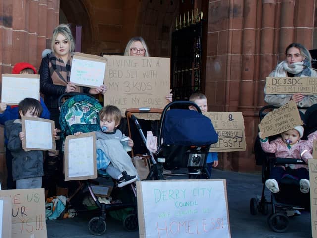 People who have been allocated new homes but have not yet got their keys protest outside the Guildhall during the meeting.