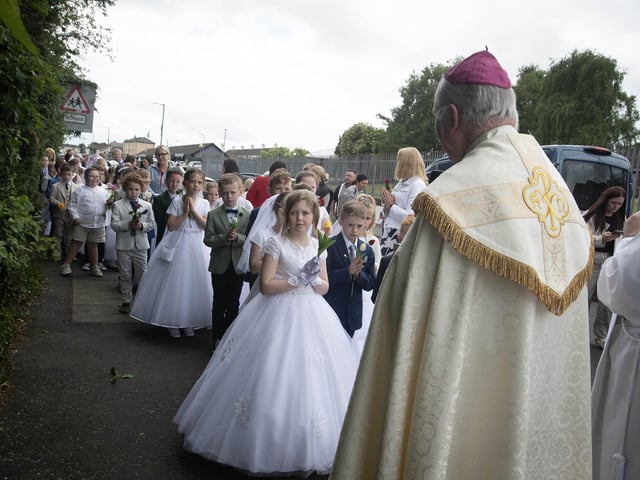 Bishop Donal McKeown awaits all the children from Holy Child to line up for procession down Fanad Drive during Thursday's May Procession to St. Mary's Church, Creggan.