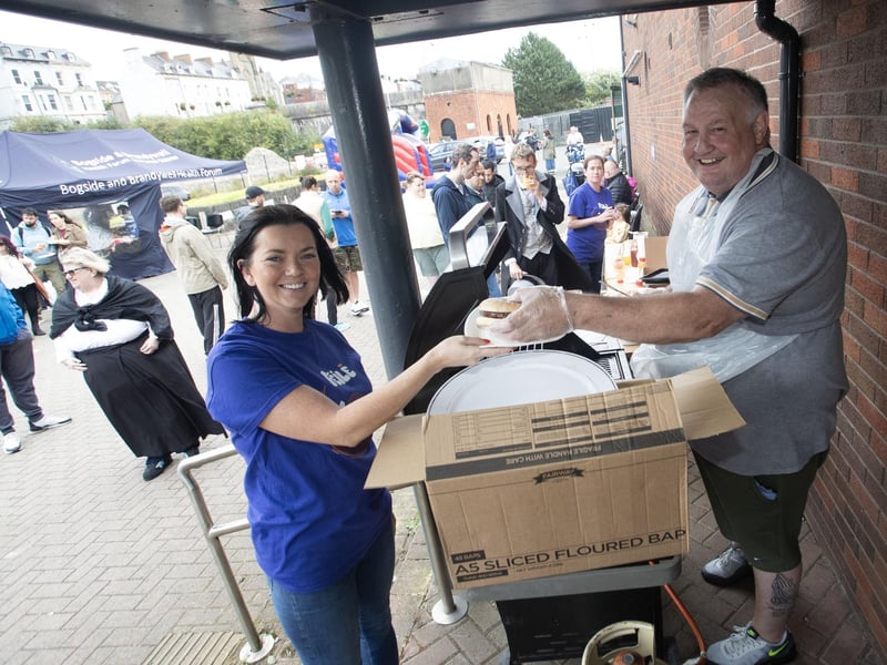 BURGER TIME!. . . .Paddy serving up the burgers with a smile to Féile's Martha Coyle during the Destined Fun. Day on Tuesday. (Photos: Jim McCafferty Photography)