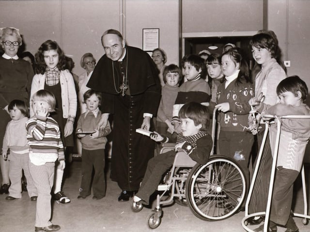 Bishop Edward Daly with local children back in February 1975.