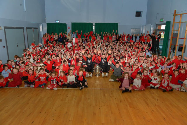 Derry City defenders Daniel Lafferty and Ciaran Coll pictured with pupils and staff from St Eithnes Primary School during a visit, with the FAI Cup, on Wednesday morning. Photo: George Sweeney.  DER2246GS  090