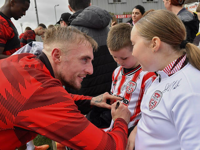 Carl Winchester signs a shirt for a fan at the Derry City open training session on Monday morning in  Brandywell Stadium. The event was organised at part of the Gasyard Feile.  Photo: George Sweeney / Derry Journal