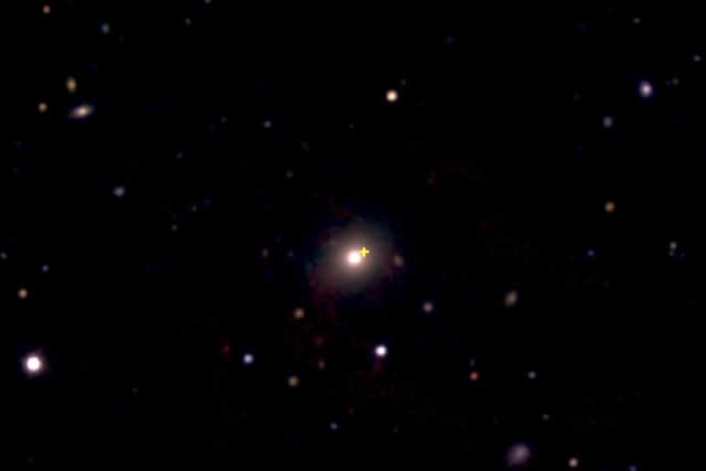 Image from the European Southern Observatory New Technology Telescope showing the distant red galaxy (centre) where the explosion occurred. The explosion site is marked by the yellow cross. (Credit: M. Nicholl)