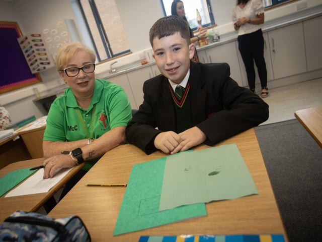 Classroom assistant Annmarie McCallion pictured with Year 8 student Kayden Williamson-Traynor at the school on Monday morning. : St. Joseph's Boys School welcomes latest influx of Year 8 pupils