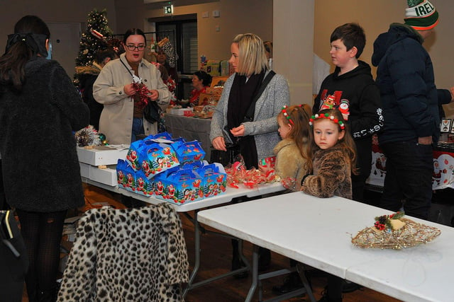 Browsing the stalls at the Galliagh Community Response Christmas Craft Fair held in Pio House Parish Centre on Saturday, in aid of Foyle Down Syndrome Trust.  Photo: George Sweeney. DER2250GS – 84