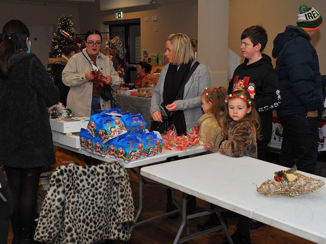 Browsing the stalls at the Galliagh Community Response Christmas Craft Fair held in Pio House Parish Centre on Saturday, in aid of Foyle Down Syndrome Trust. Photo: George Sweeney. DER2250GS – 84