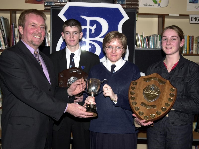 Mr. Aidan McKinney, Board of Governors, left, preseting the Northern Bank Cup for Mathematics to Michelle McGowan. Included are  Martin Starrett (Single Science Award) and Tracey McCay (Double Science Award). (1/12/CD12) : Pictured are students, staff and invited guests at the annual school prize-giving at St Brecan's High School, Top of the Hill back in the year 2000.