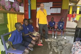 The founder of Hands for Hope School in Kampala, Joe Cummiskey, pictured with some students. The school, which educates children from Manuwongo slum, will benefit from the concert.