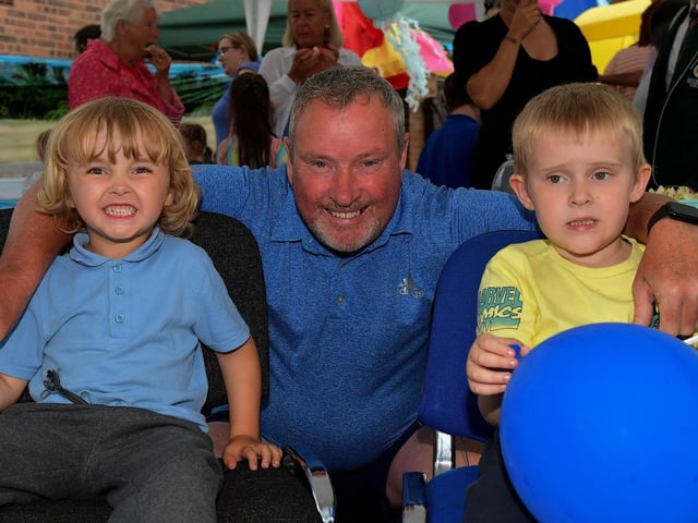 Martin McVeigh with his grandchildren Zac and Jacob at the recent Habinteg Big Beach Lunch at Farland Way. Photo: George Sweeney. DER2325GS – 030