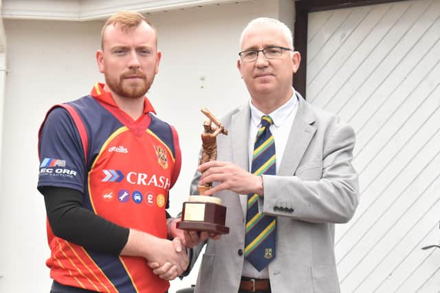 Brigade's David Barr collects the cup final 'Player-of-the-Match' trophy from North West Chairperson, Brian Dougherty.