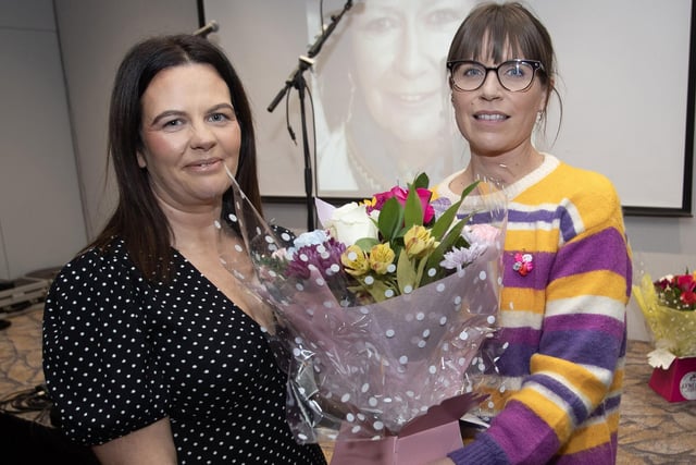 Áine Barton presents a bouquet of flowers to Catherine Pollock during Friday's tribute to Áine's late mother Roisin at the Maldron Hotel. Catherine was recognised for her contribution as a community activist.