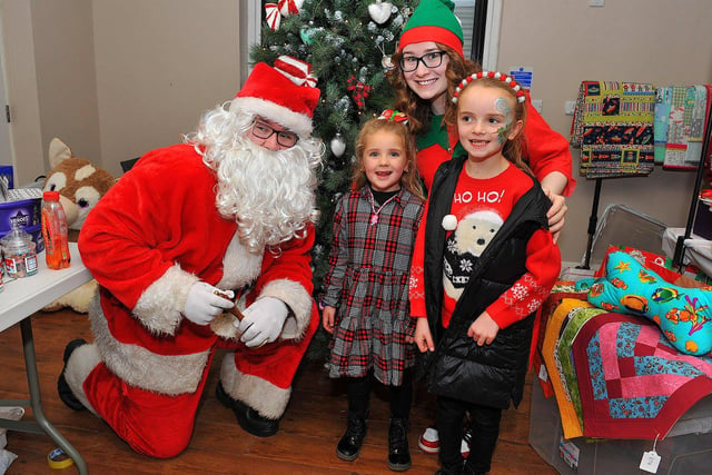 Posing for a picture with Santa at the Galliagh Community Response Christmas Craft Fair held in Pio House Parish Centre on Saturday, in aid of Foyle Down Syndrome Trust.  Photo: George Sweeney. DER2250GS – 88
