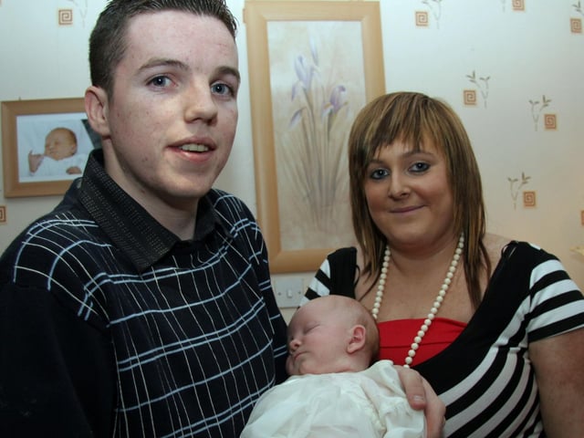 Godparents William and Andrea pose for a photograph with baby Megan 0046JML : Parties and celebrations March 2006: Megan Ann Eileen Smith.