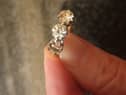 A picture of the ring with the diamond missing.
